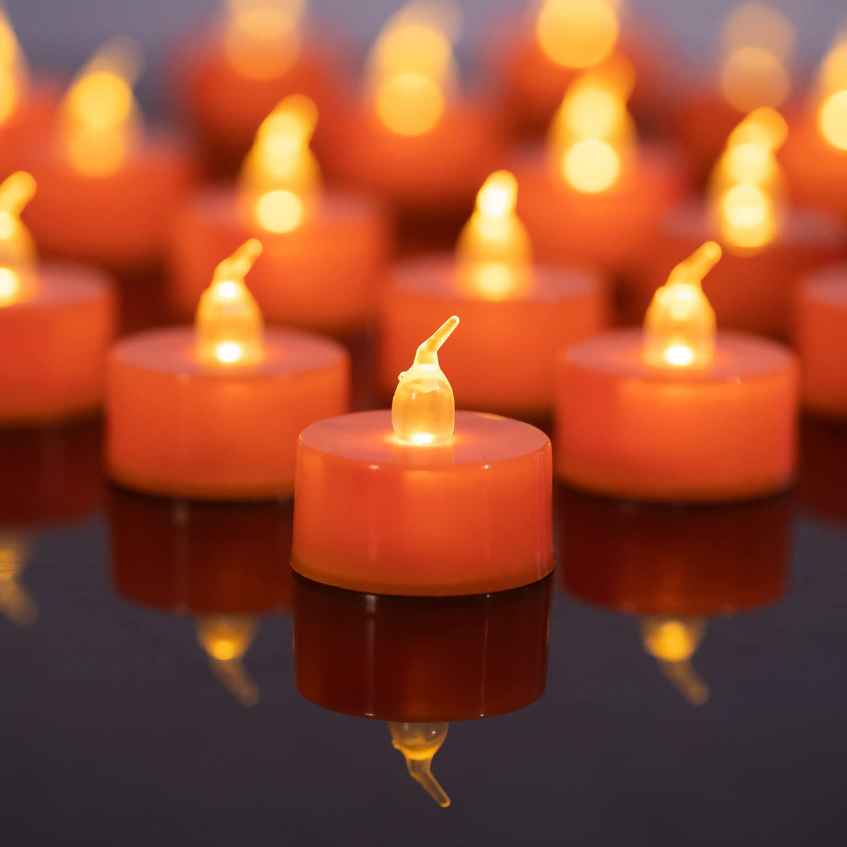 LANKER 24 Pack Orange Tea Lights Candles, Flickering Warm Yellow Flameless LED Tealights, Long Lasting Battery Operated Fake Can